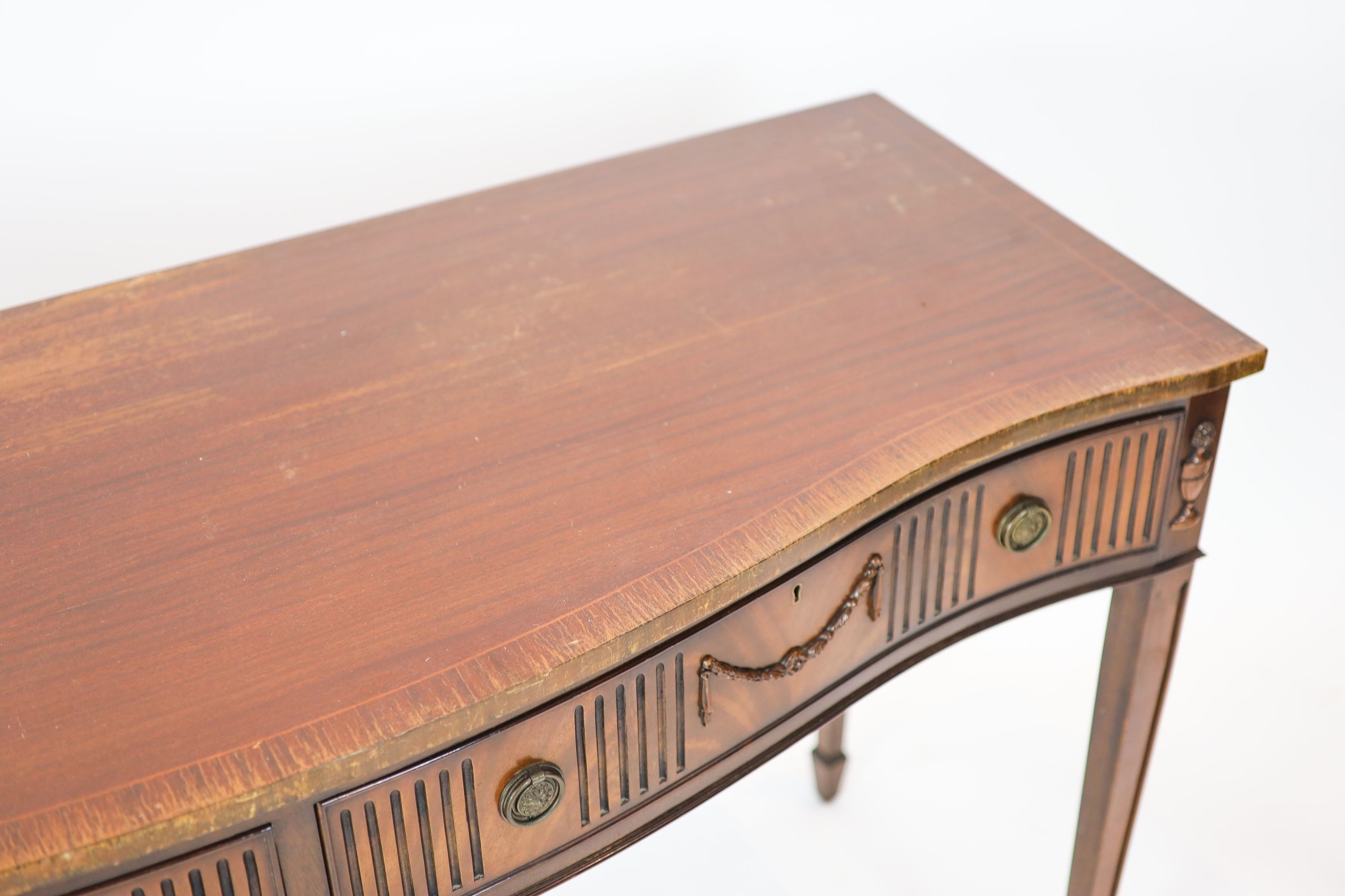 A George III style mahogany serpentine fronted serving table, width 153cm, depth 57cm height 88cm